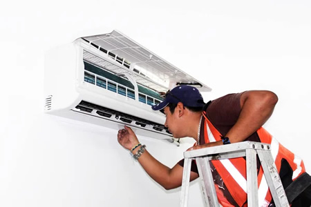 Technician installing a ductless mini-split inside a Los Angeles bungalow